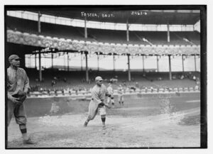 A baseball pitcher delivering