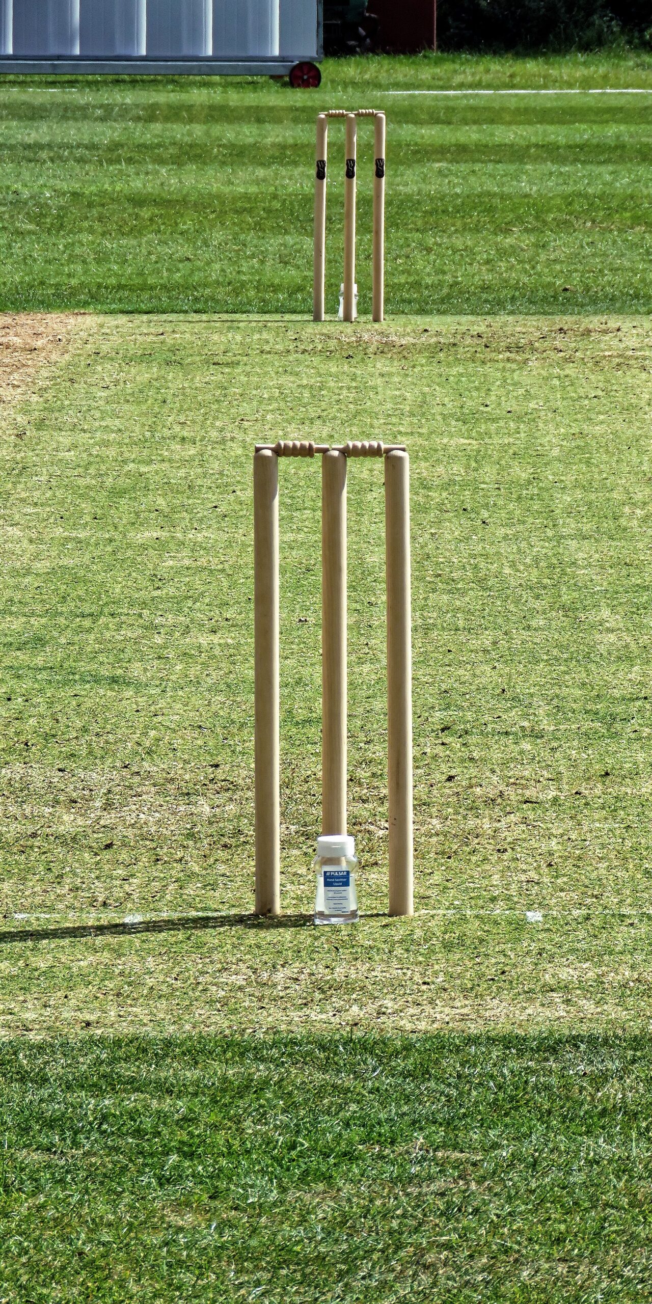 A batter defending the stumps in cricket