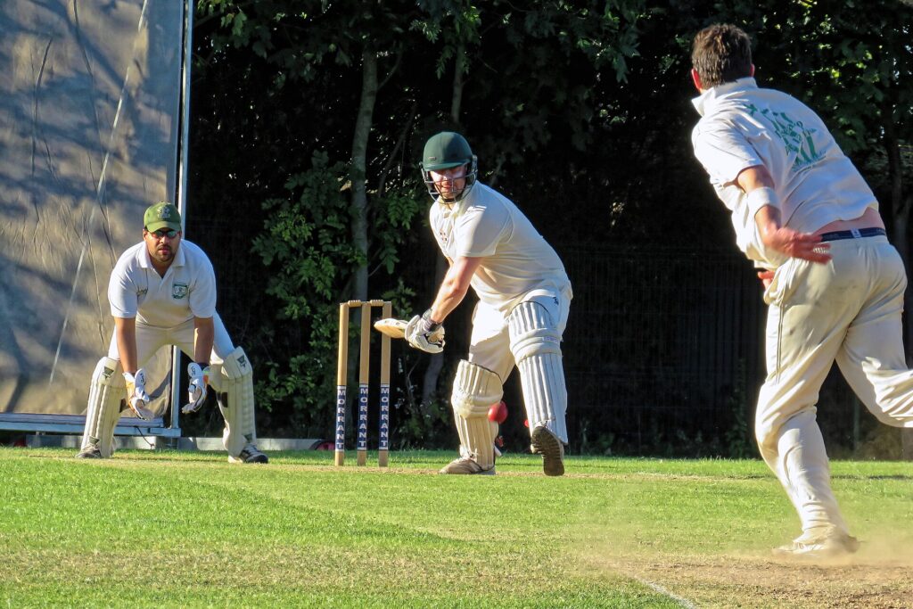 A bowler in his delivery stride