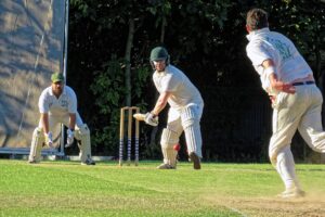 A bowler in his delivery stride