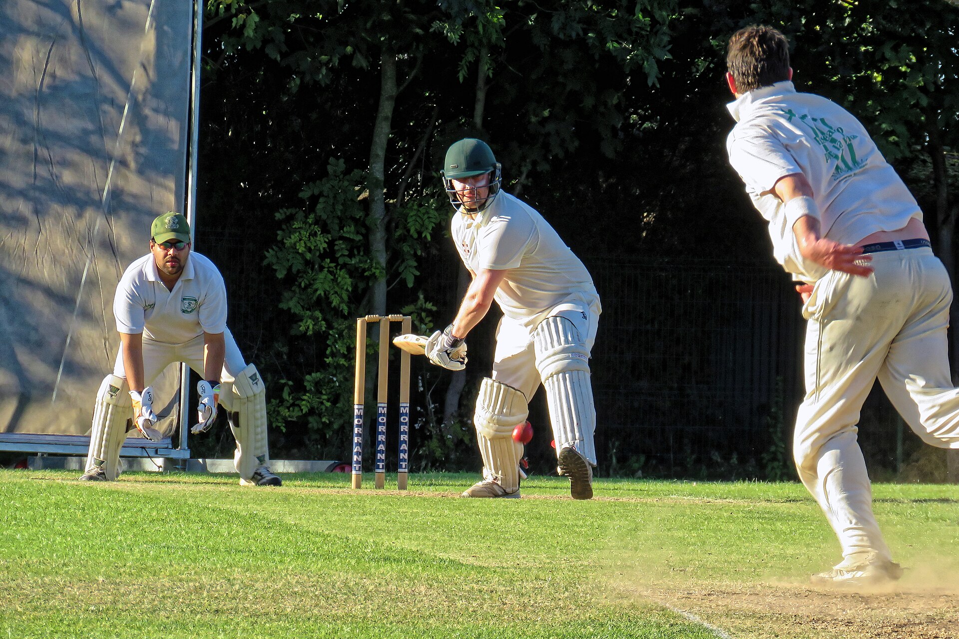 A bowler in his delivery stride