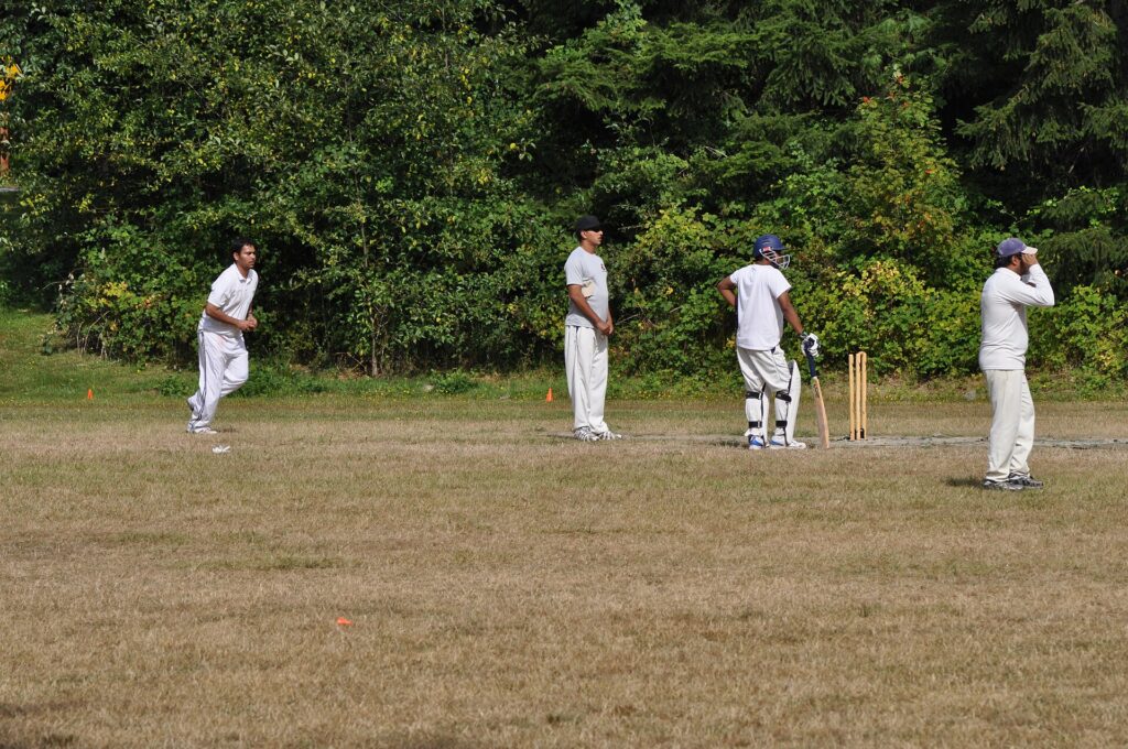 A spin bowler in delivery