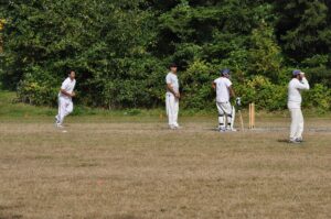 A spin bowler in delivery