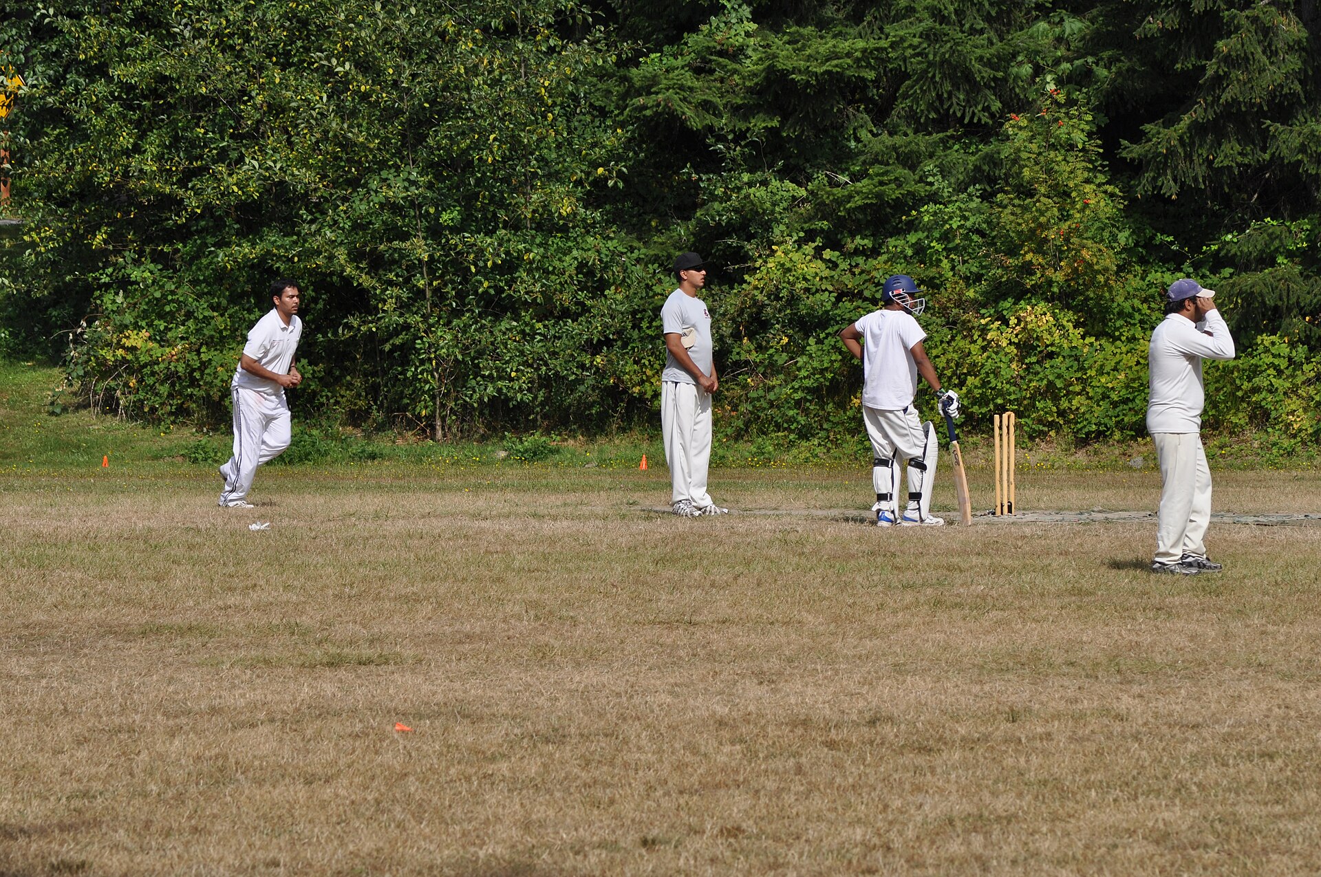 A spin bowler in delivery