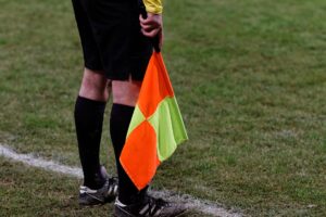 An assistant referee signalling offside