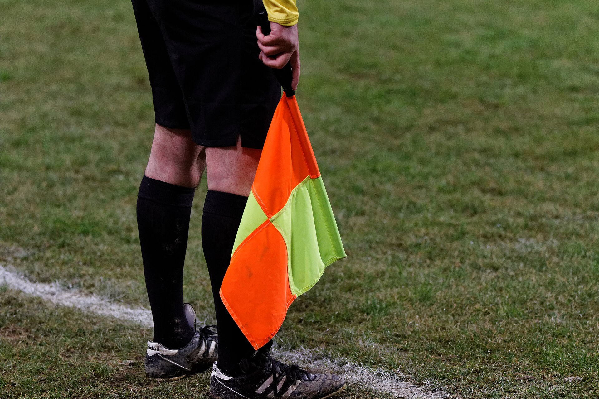 An assistant referee signalling offside